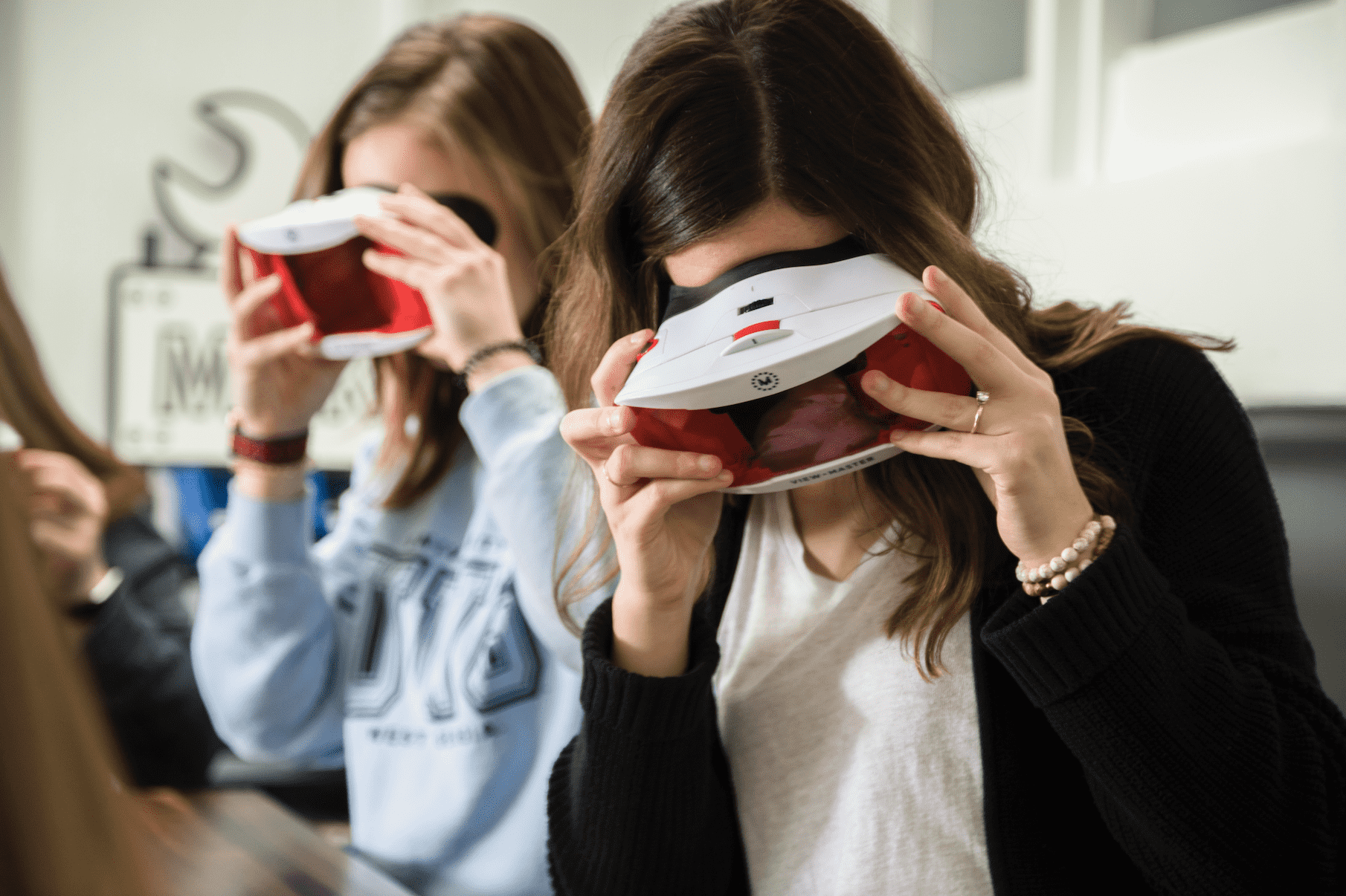 Two adults using vision goggles