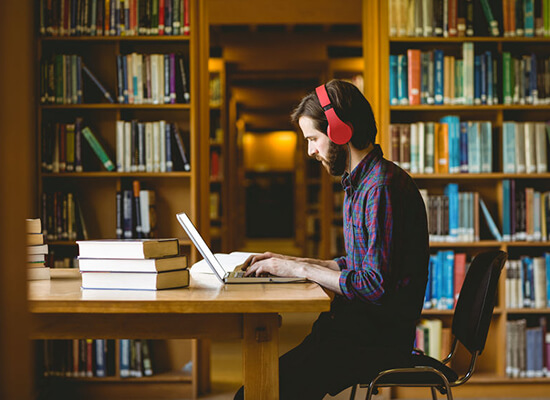 UWG student studying with headphones on. 