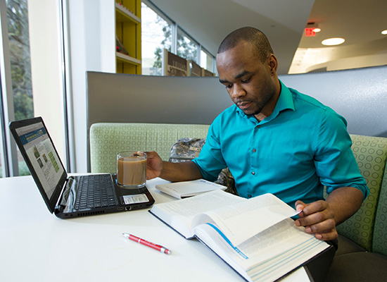 UWG student studying in the library. 