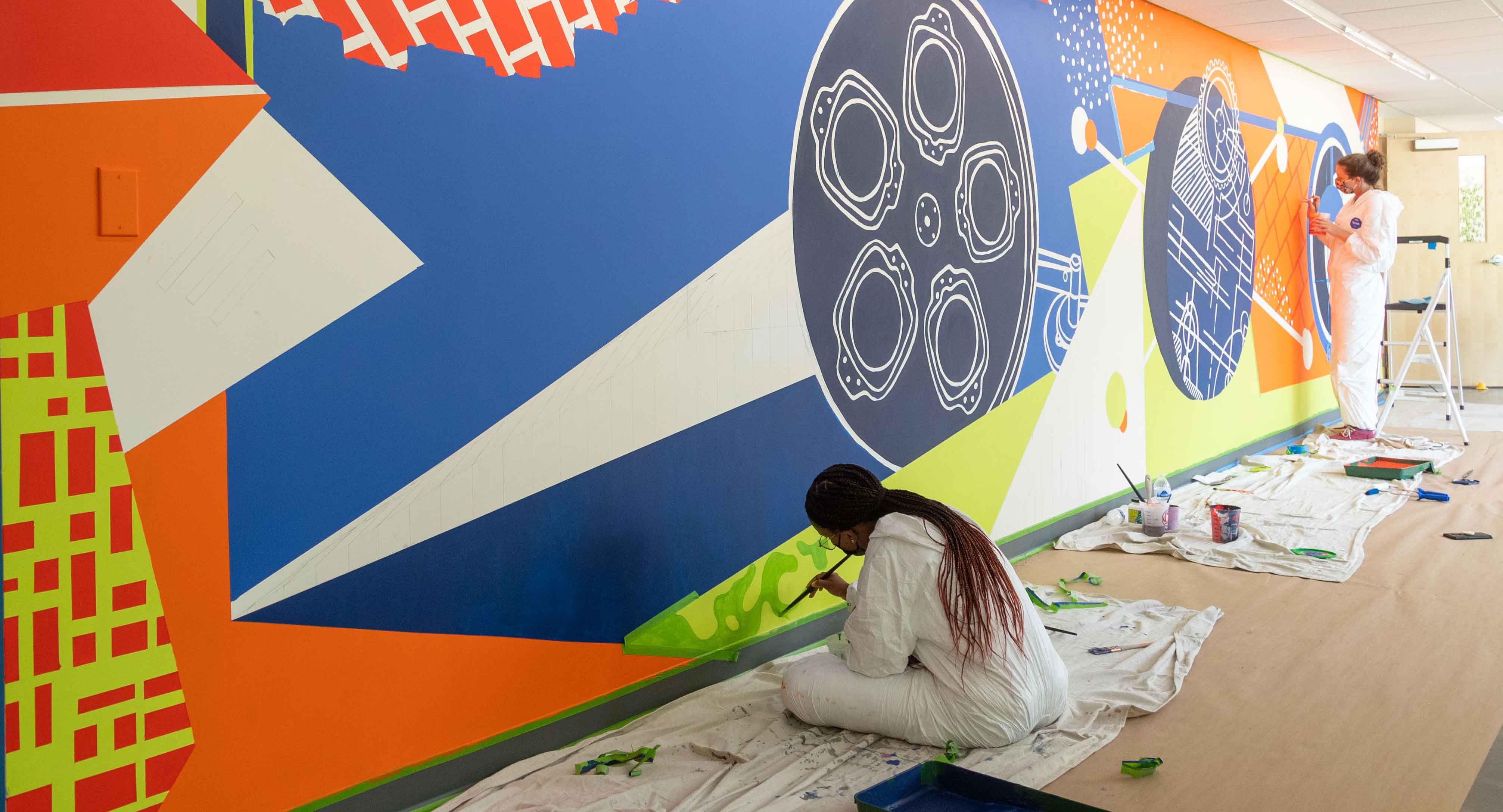students working on a mural at the newnan campus