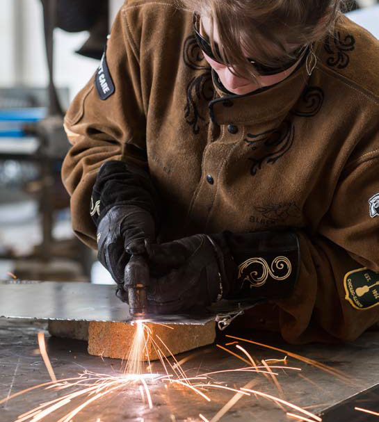 Art student welding metal.