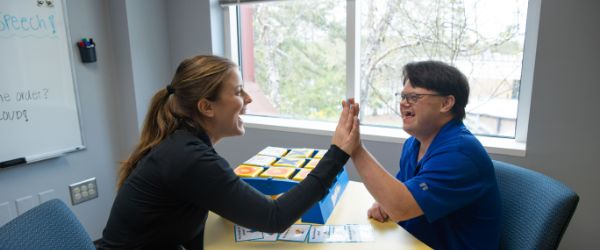 Clinic students working with elementary aged children