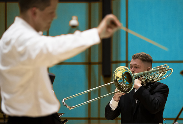 wind ensemble director and student playing trombone