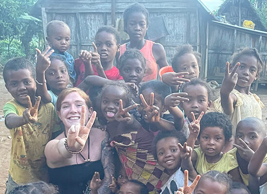 UWG alumna and Peace Corp volunteer Mackenzie Hafer in Madagascar with children