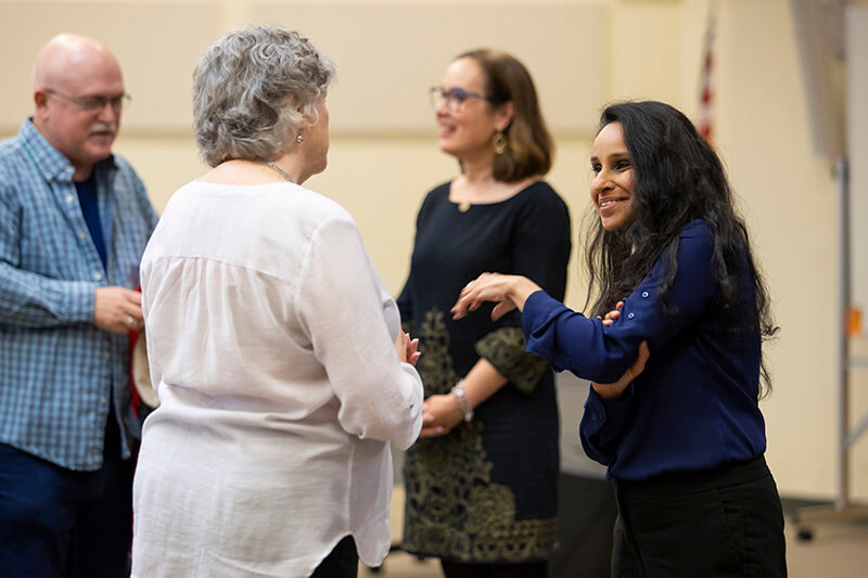 People chatting at a UWG event