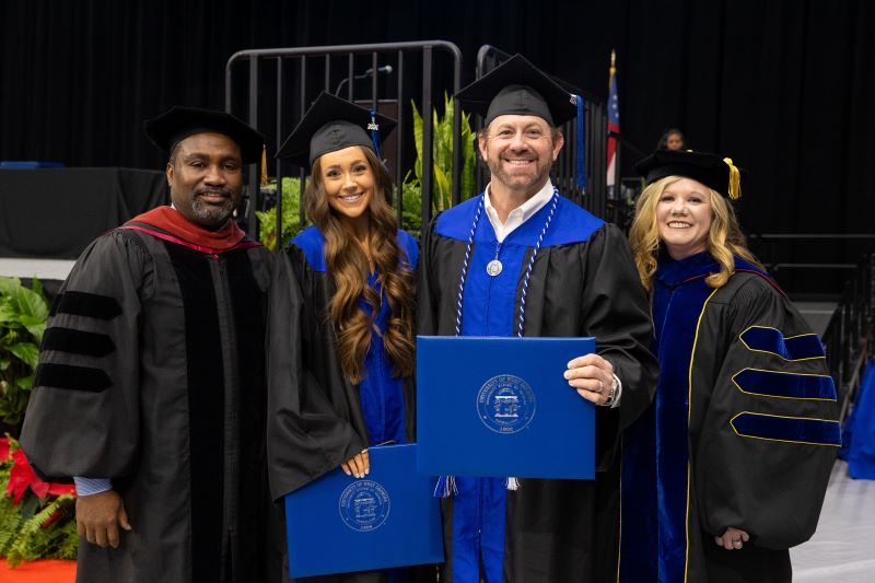 L to R: Dr. Christopher Johnson, Richards College of Business dean; Addison Camp; Greg Camp; Dr. Karen Owen, University College dean