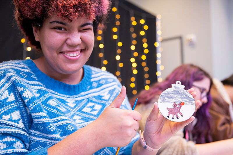 UWG student with a holiday ornament