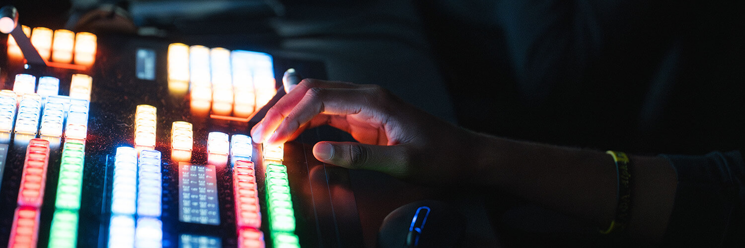 Hands at a colorful switchboard