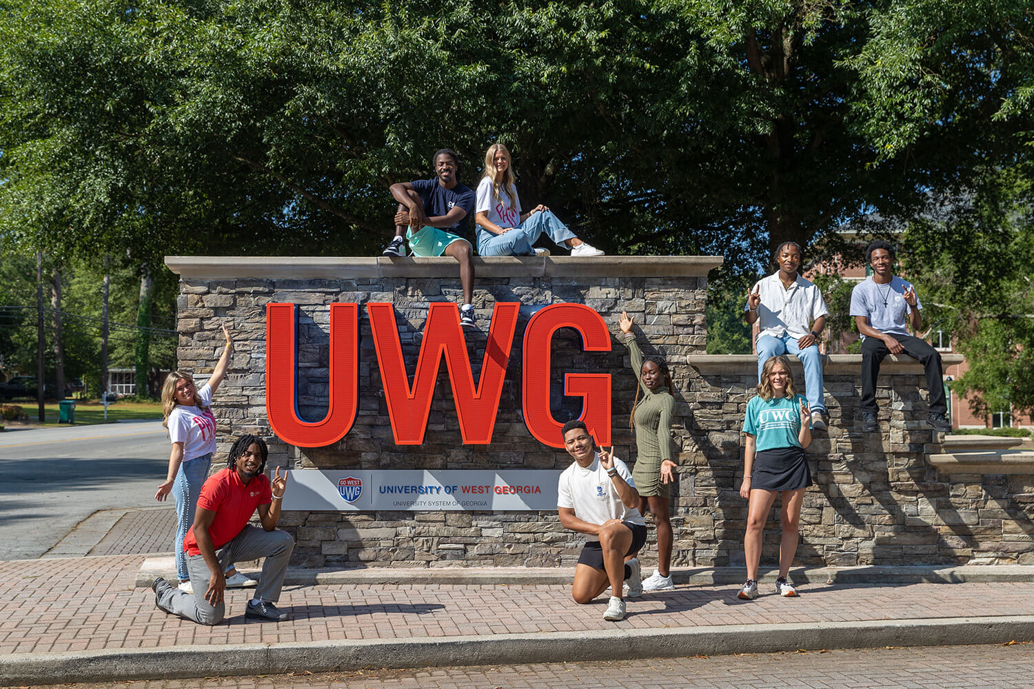 UWG students at the entrance sign