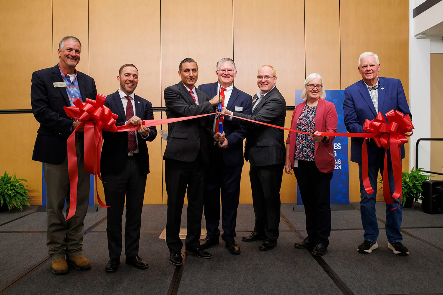 UWG administrators and faculty and community members at a ribbon-cutting ceremony