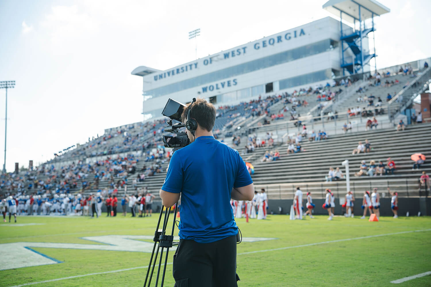 UWG student filming a football game at University Stadium for ESPN+