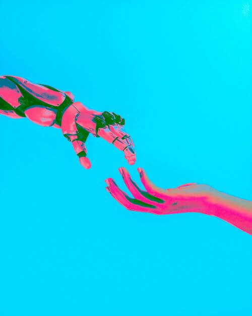 Robot hand and human hand reaching out to each other