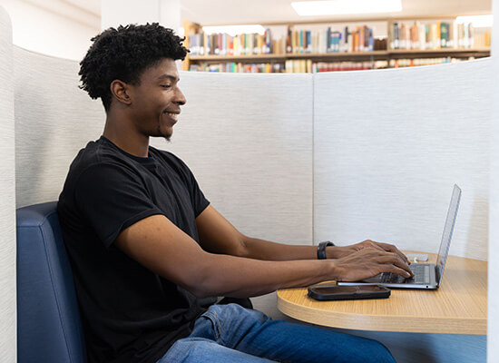 UWG online student working at a laptop