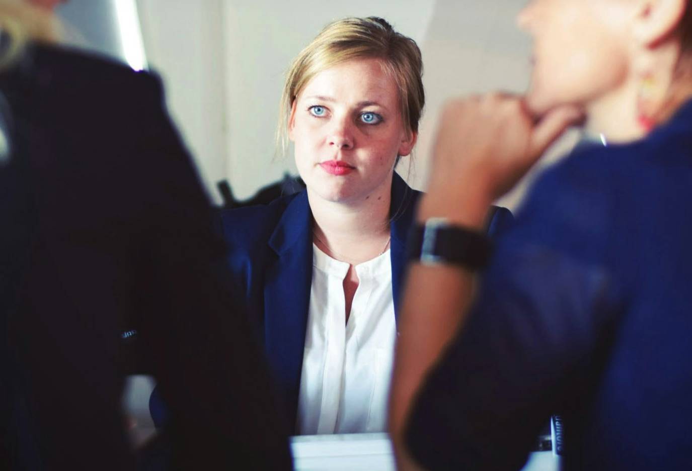 young women at table facing two professionals