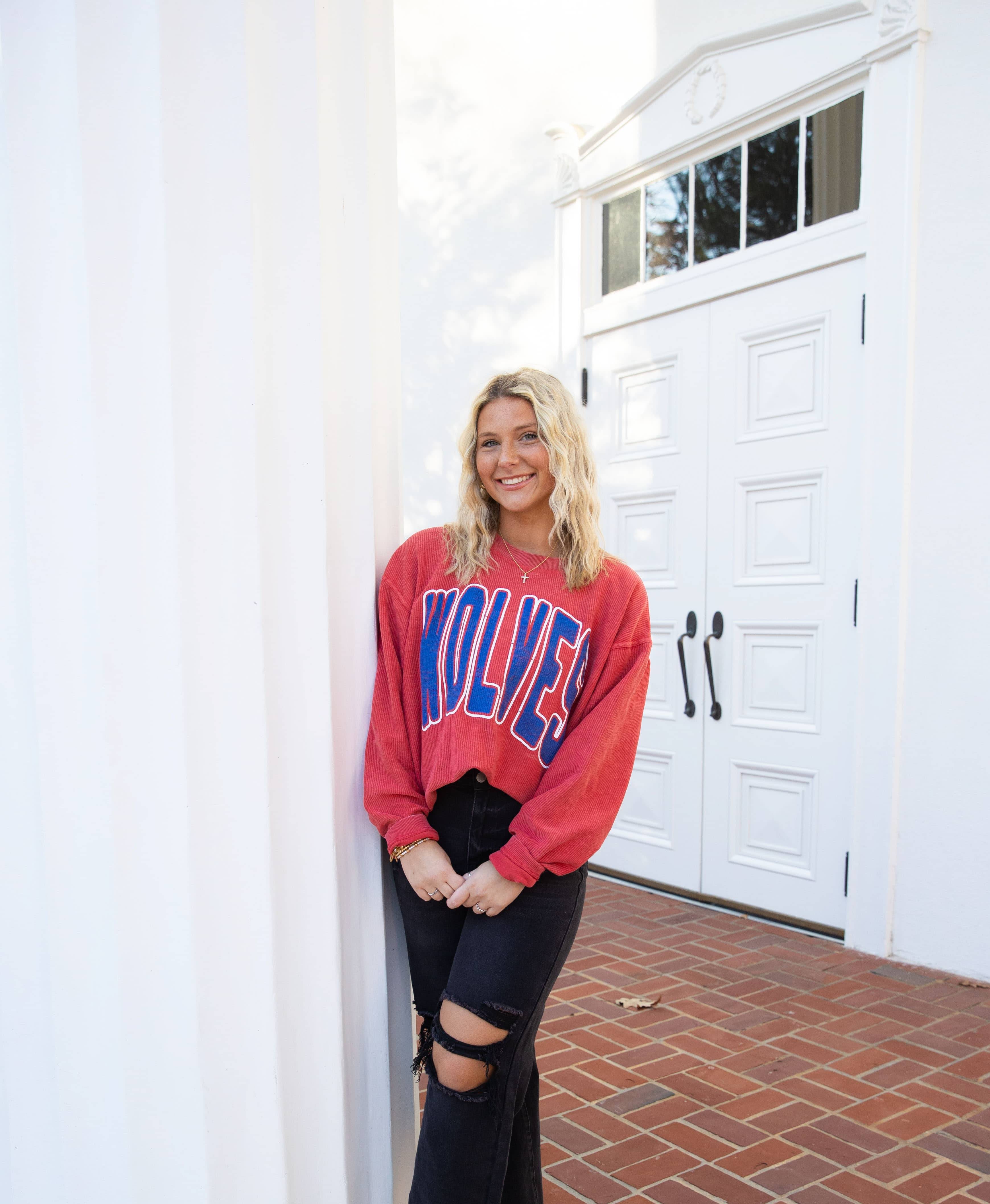 Emily Howie posing for an outside portait in her UWG attire.