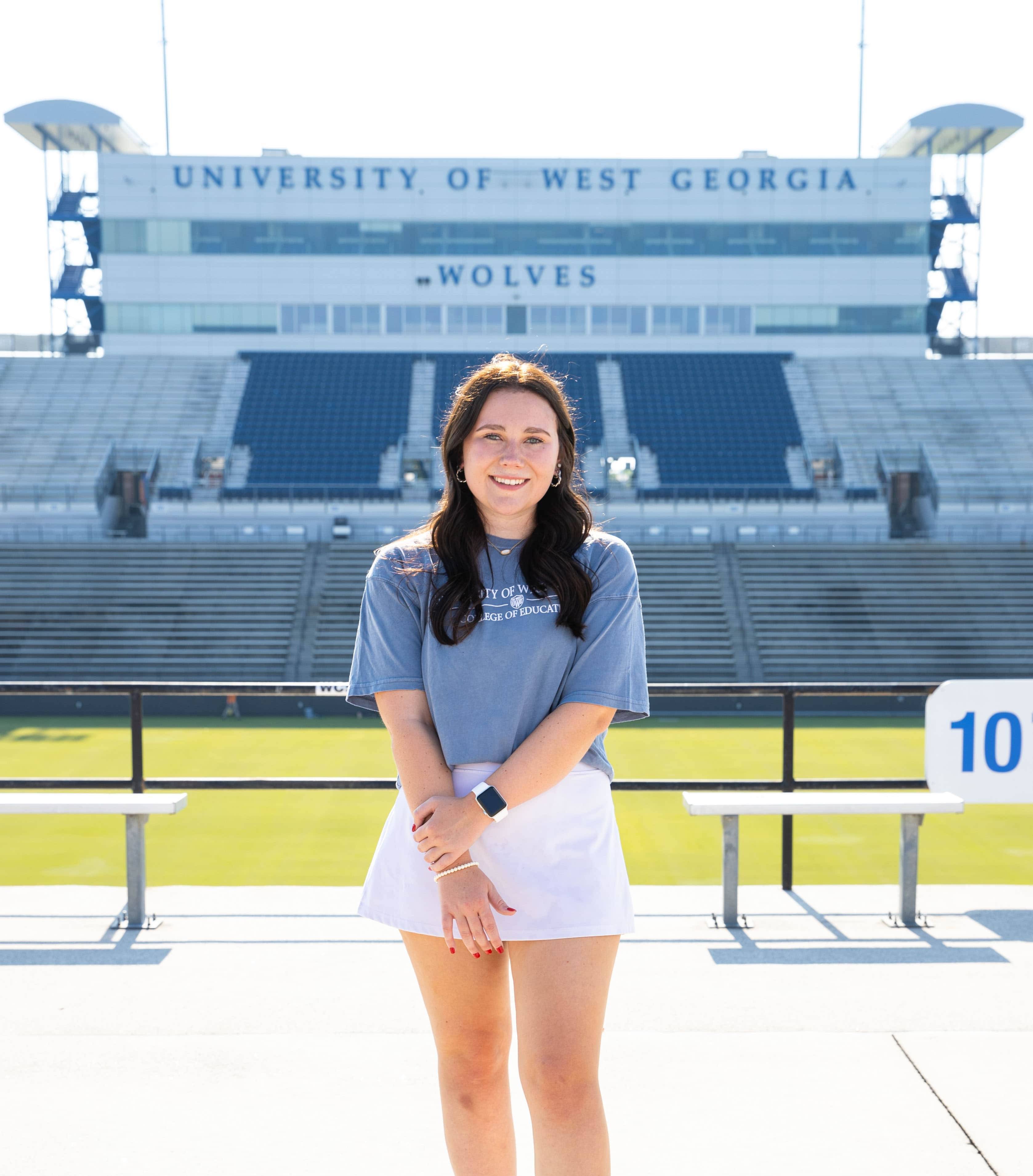 Grace Katherine James posing for an outside portait in the stadium.