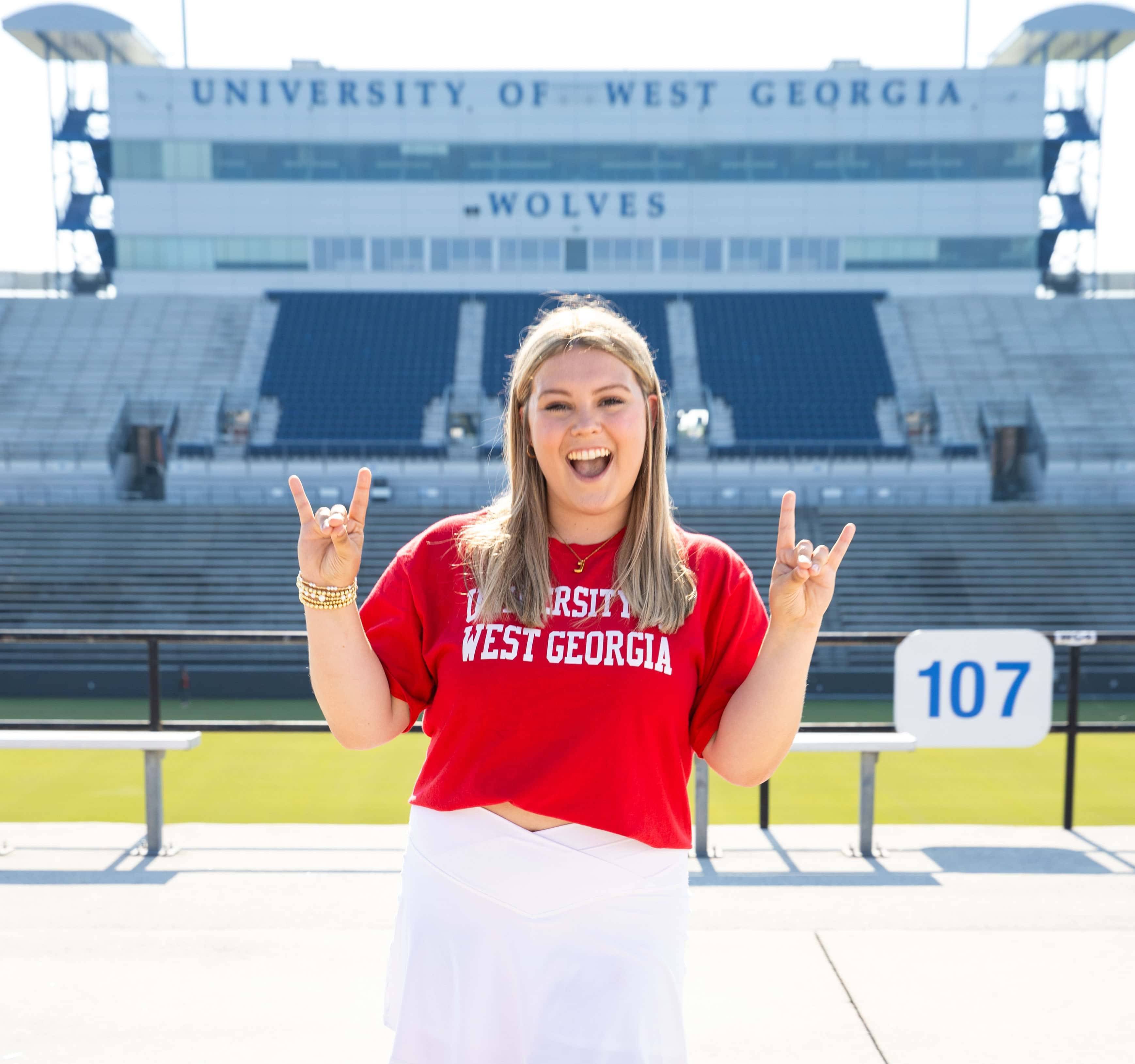 Jayra Stansell posing outside the university stadium.