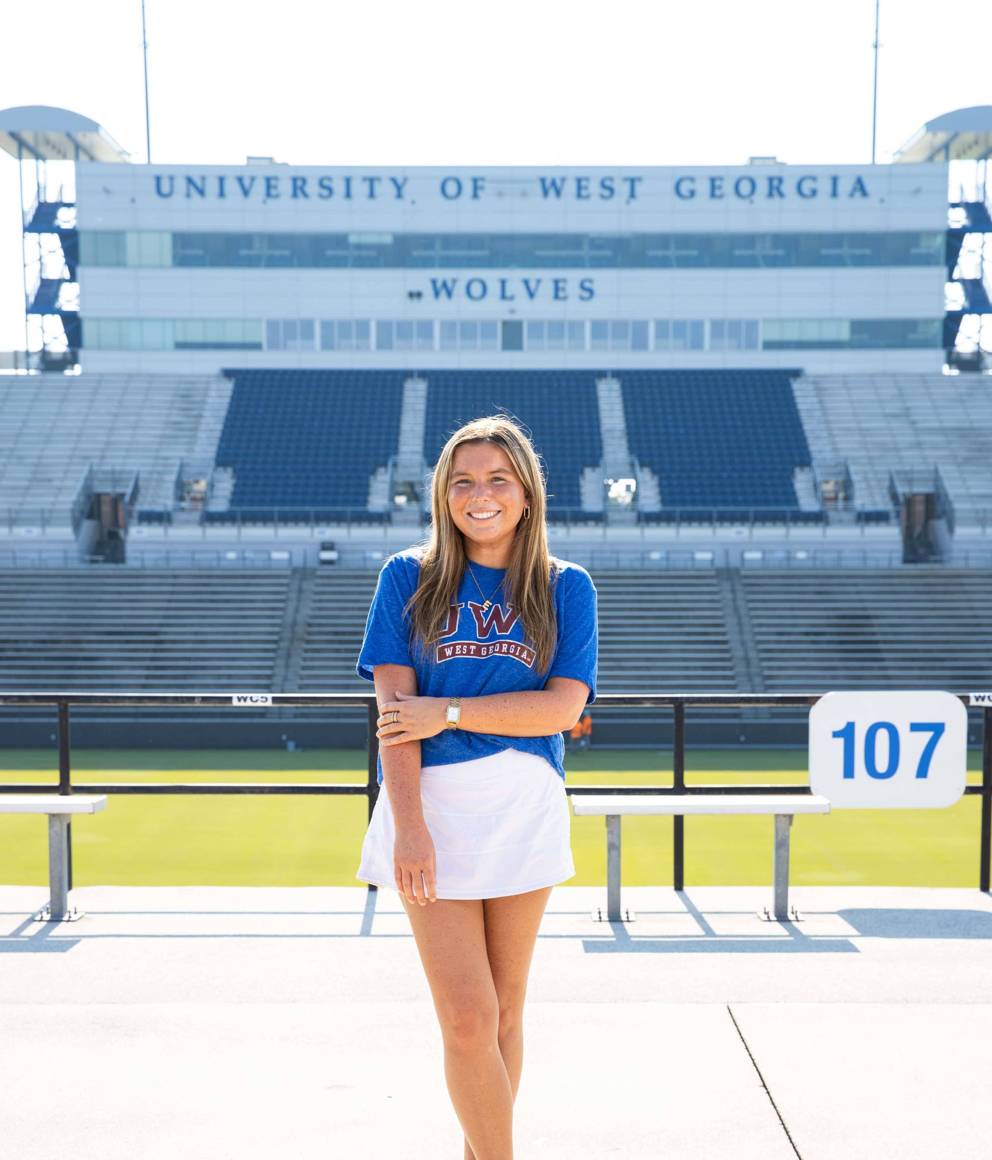 Emily Ficus posing for an outside portait in the stadium.