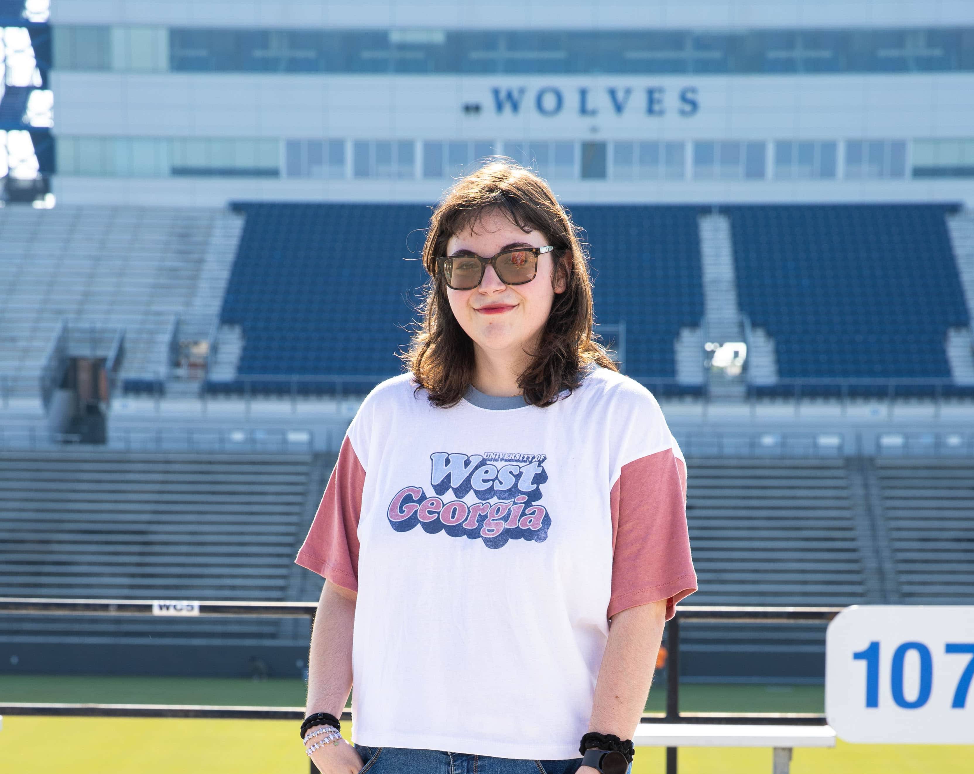 Ansleigh posing for an outside portait in the football stadium.