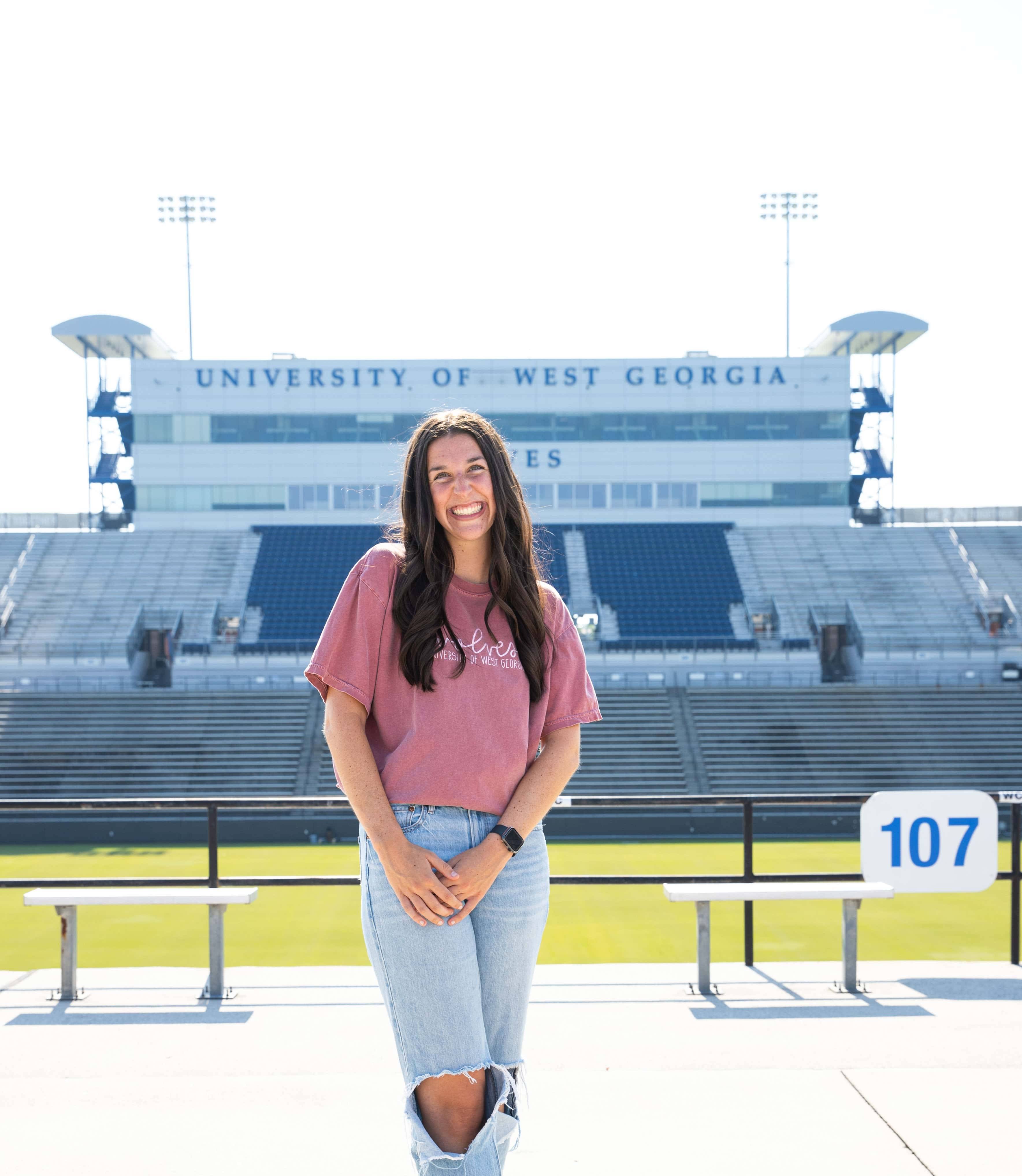 Lauren O'Bryan posing in front of the stadium.