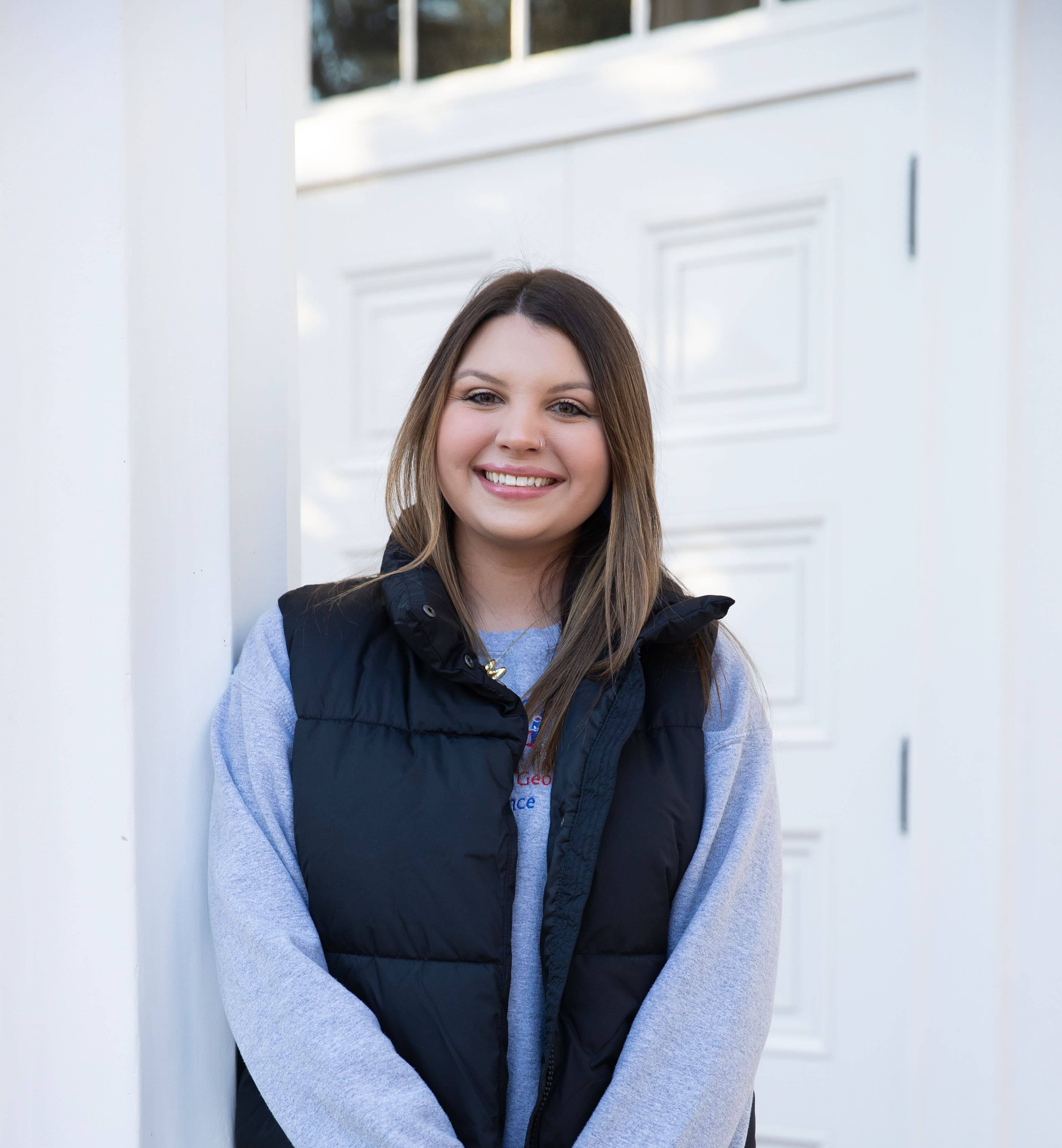 Madison posing for outside for portaits wearing her UWG attire.