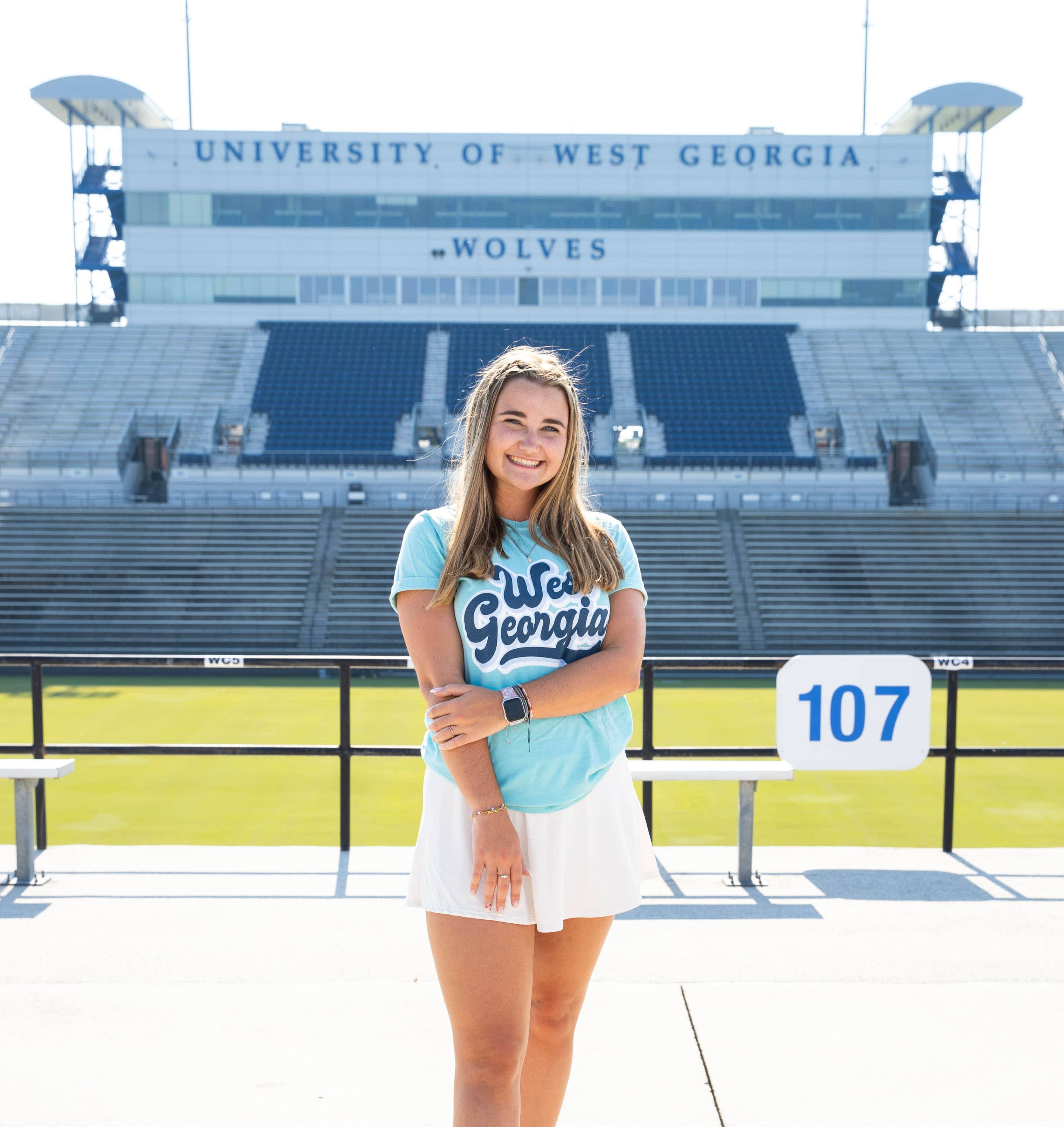 Tabitha Martin posing for an outside portait in the stadium.