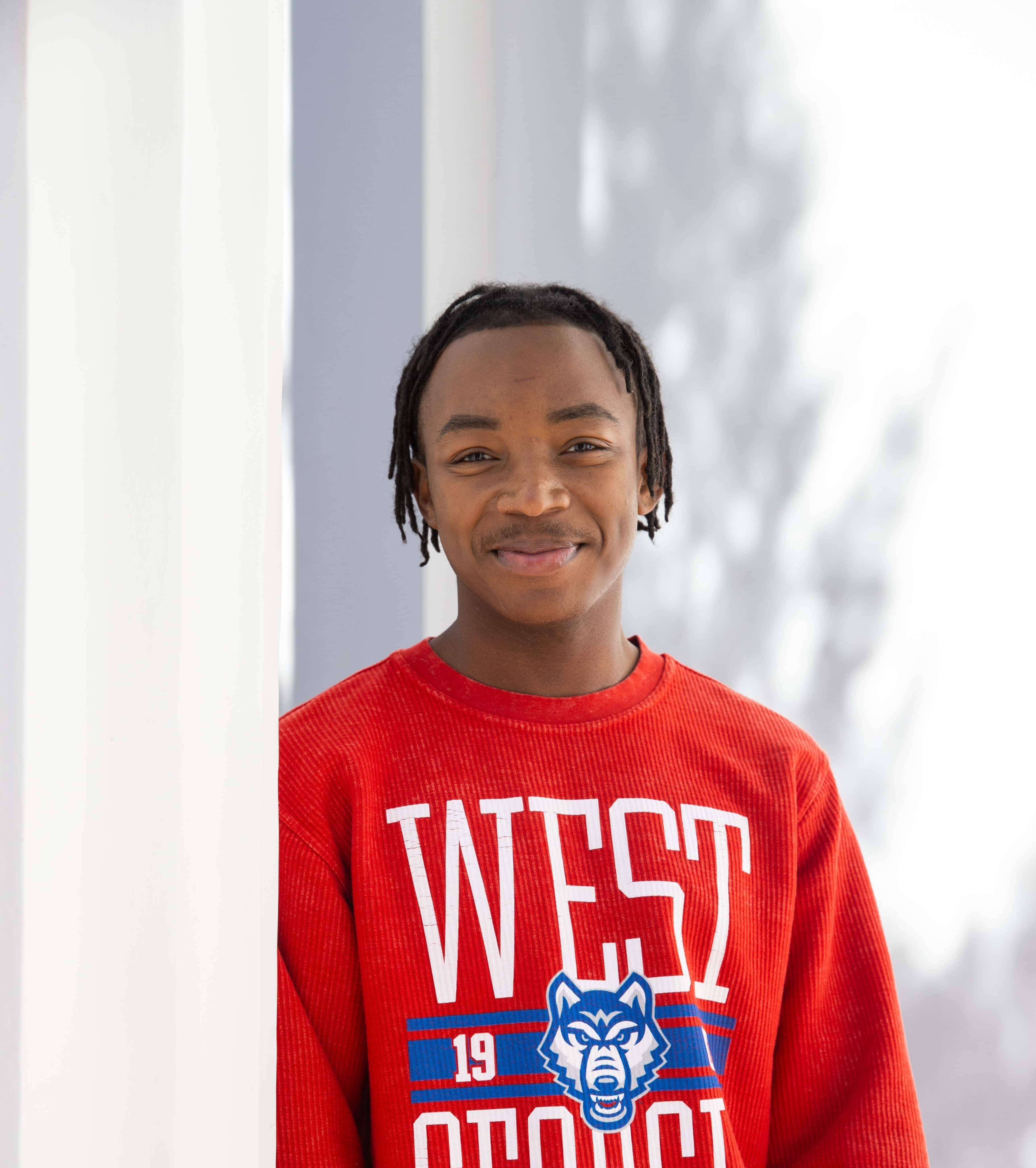 Tristian posing for outside for a photoshoot in her UWG attire.