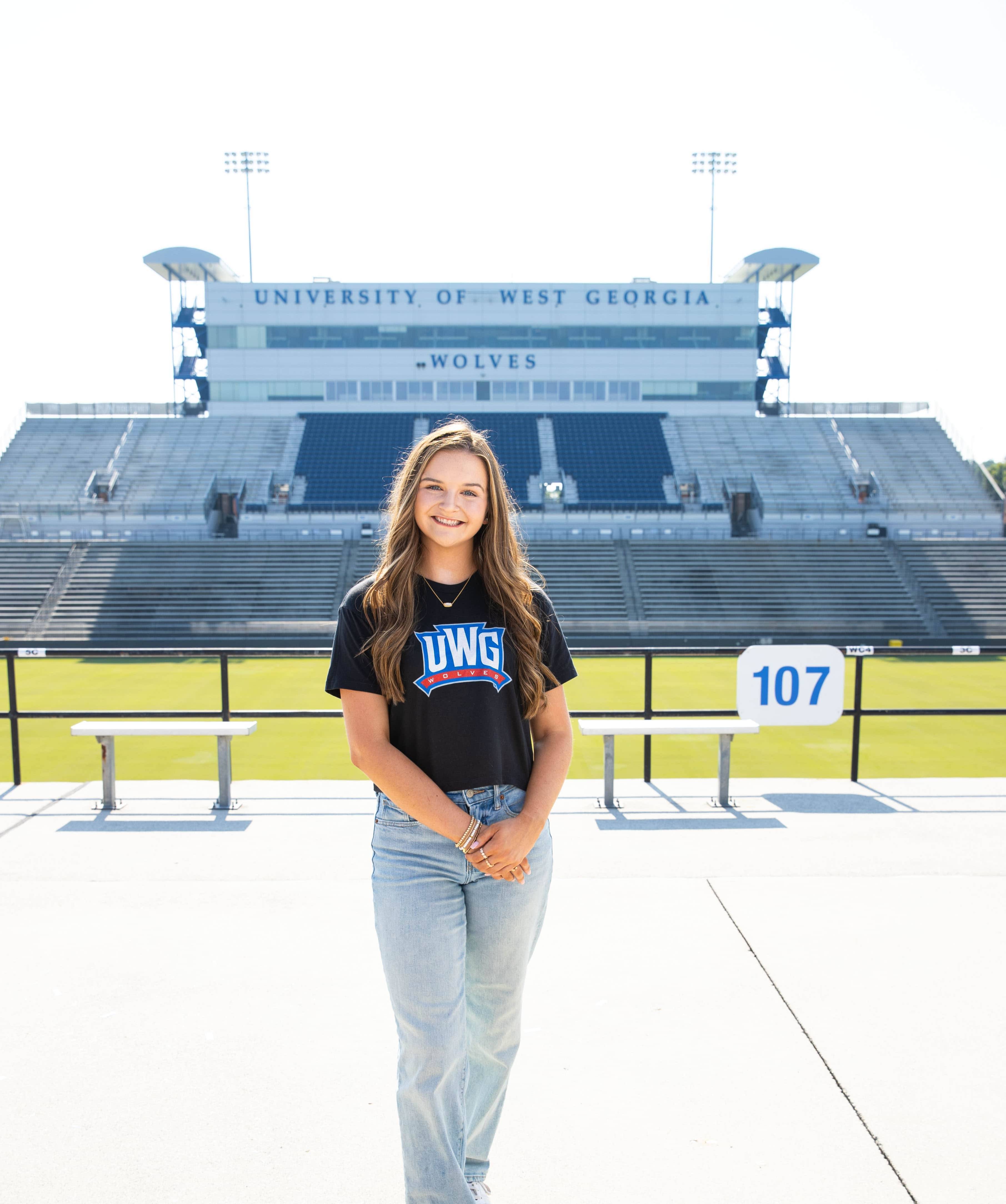 Ella Tankersly posing for an outside portait in the stadium.