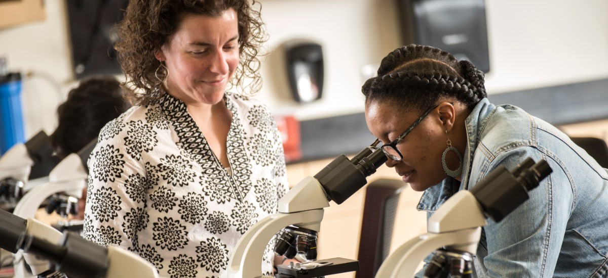 professor and student with microscope